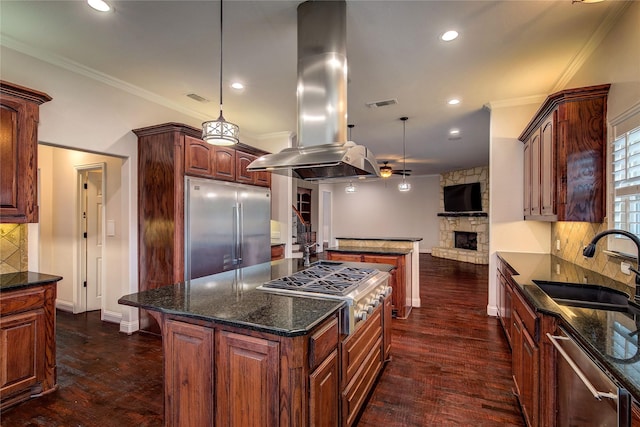 4676 County Road 2230, Caddo Mills, TX 75135 - kitchen with stainless steel appliances, island range hood, a sink, a fireplace, and backsplash