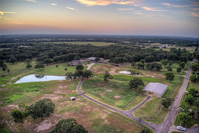 aerial view at dusk with a water view