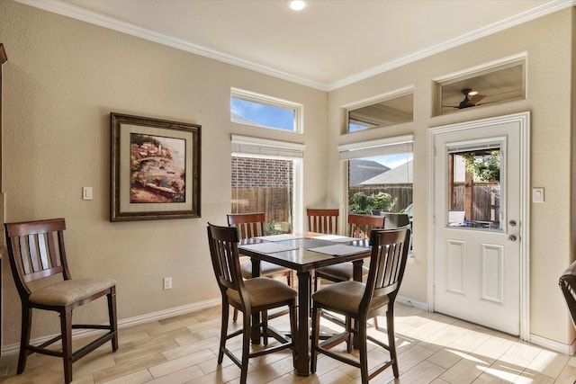 dining room featuring light wood-type flooring, ceiling fan, and crown molding