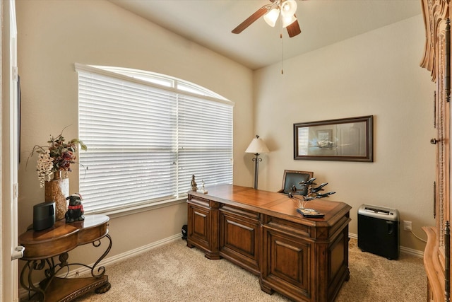 carpeted office space with ceiling fan and a healthy amount of sunlight