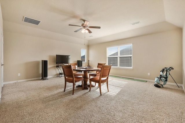 dining room with ceiling fan, light carpet, and lofted ceiling