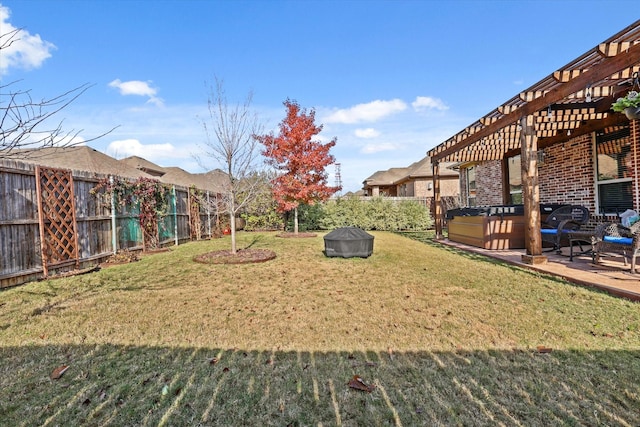 view of property's community with a pergola, a lawn, and a hot tub