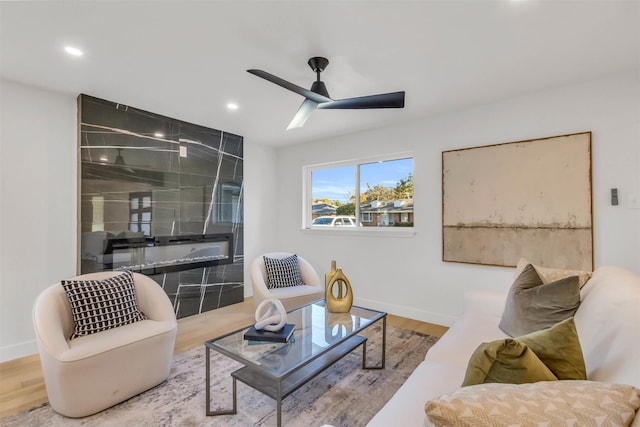 living room with wood-type flooring and ceiling fan