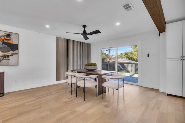 dining space with beam ceiling, ceiling fan, and light hardwood / wood-style flooring