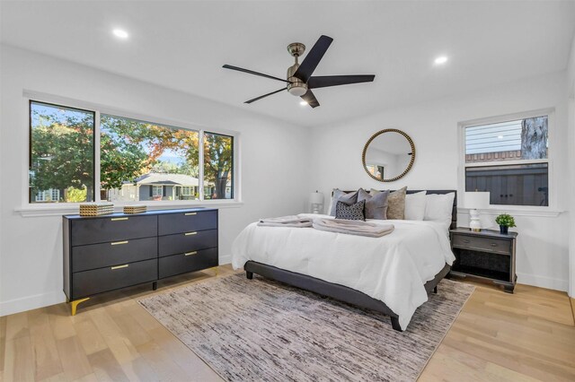 bedroom with ceiling fan and light hardwood / wood-style floors