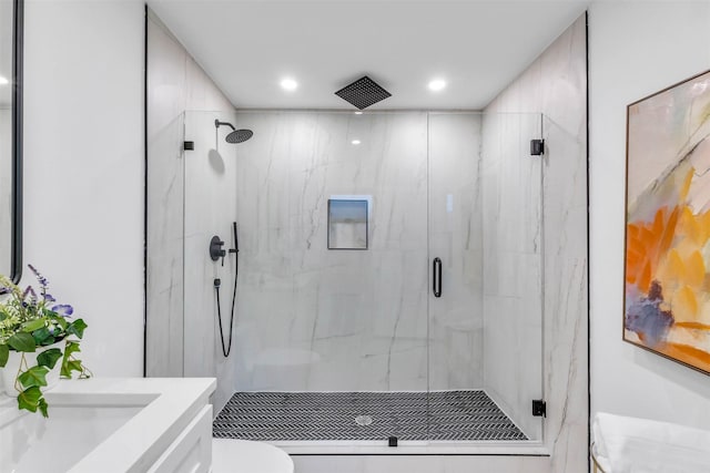 bathroom featuring walk in shower, vanity, and toilet