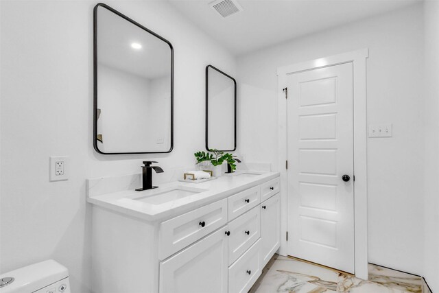 bathroom with vanity and toilet