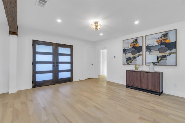 entrance foyer with light hardwood / wood-style flooring and french doors