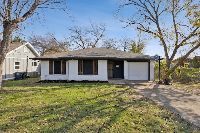 view of front of house with a garage, a front yard, and central AC