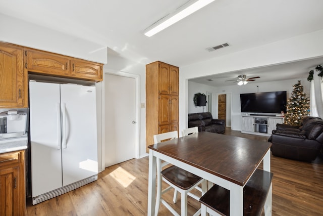 kitchen with ceiling fan, light hardwood / wood-style flooring, and white appliances