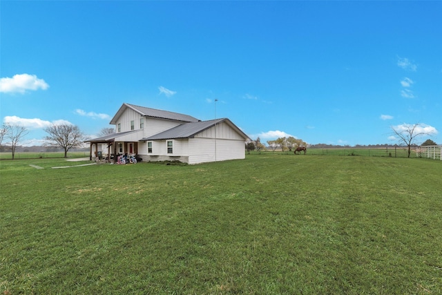 view of property exterior featuring a yard and a rural view