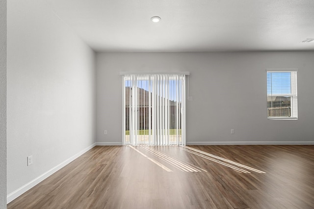 spare room featuring hardwood / wood-style flooring and a wealth of natural light