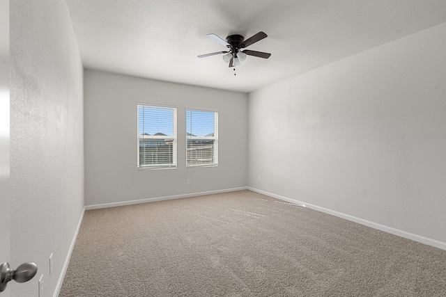 unfurnished room with ceiling fan and carpet floors