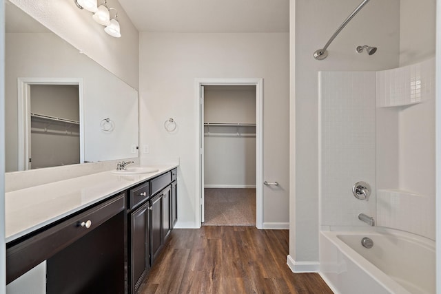 bathroom featuring vanity, wood-type flooring, and shower / tub combination