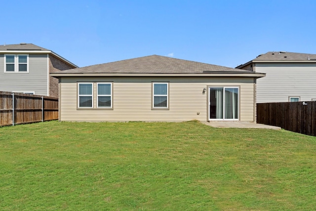 back of house with a yard and a patio