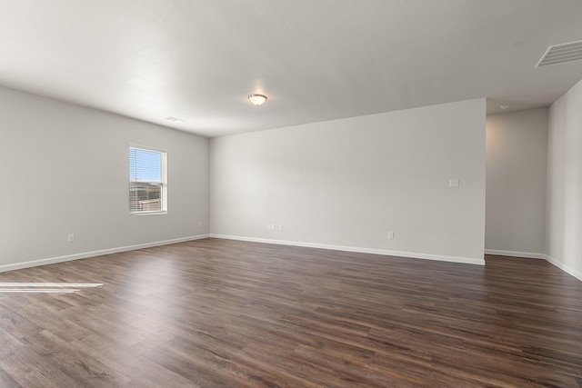 spare room featuring dark hardwood / wood-style floors