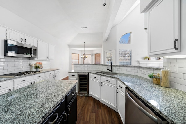 kitchen with white cabinets, wine cooler, sink, and appliances with stainless steel finishes