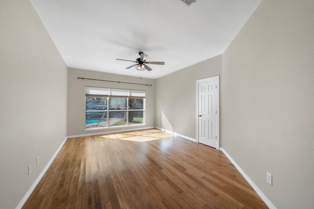 empty room featuring hardwood / wood-style flooring and ceiling fan