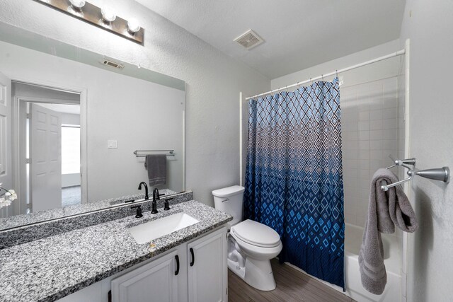 full bathroom featuring wood-type flooring, vanity, toilet, and shower / bath combo with shower curtain