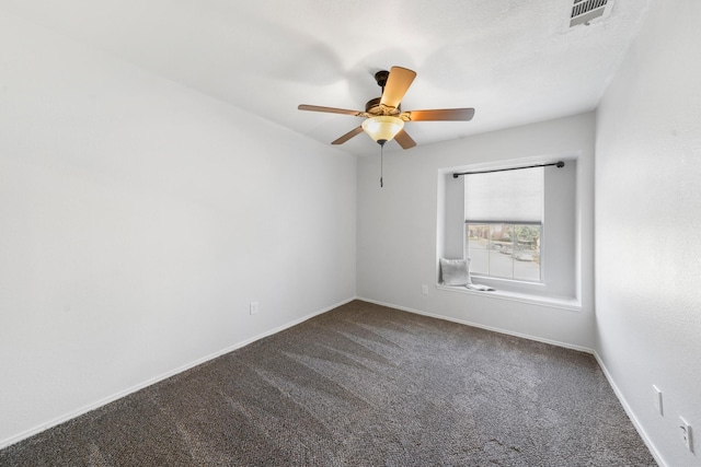 carpeted spare room featuring ceiling fan