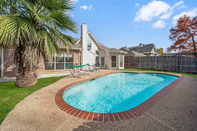 view of swimming pool featuring a patio area