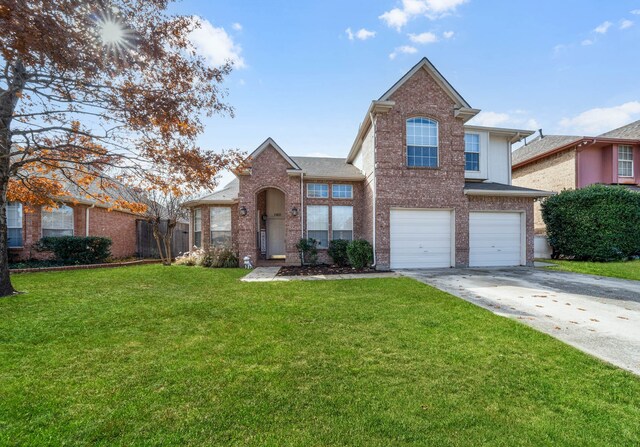 view of property featuring a front yard and a garage