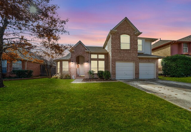 front facade with a lawn and a garage