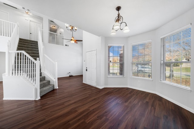 foyer entrance with ceiling fan with notable chandelier and dark hardwood / wood-style floors