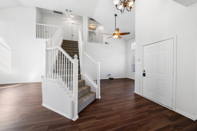 entryway featuring dark hardwood / wood-style floors, ceiling fan with notable chandelier, and high vaulted ceiling