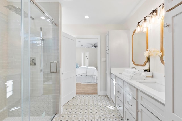 bathroom with ceiling fan, vanity, and an enclosed shower