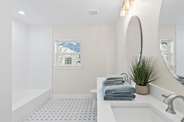 bathroom featuring vanity and toilet