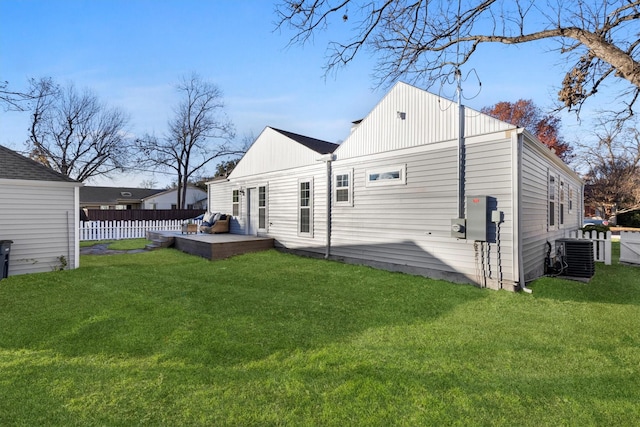 rear view of house featuring a lawn