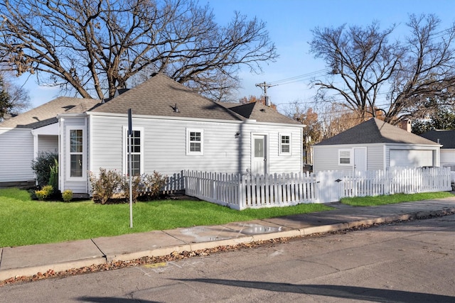 view of front of house with a garage and a front lawn