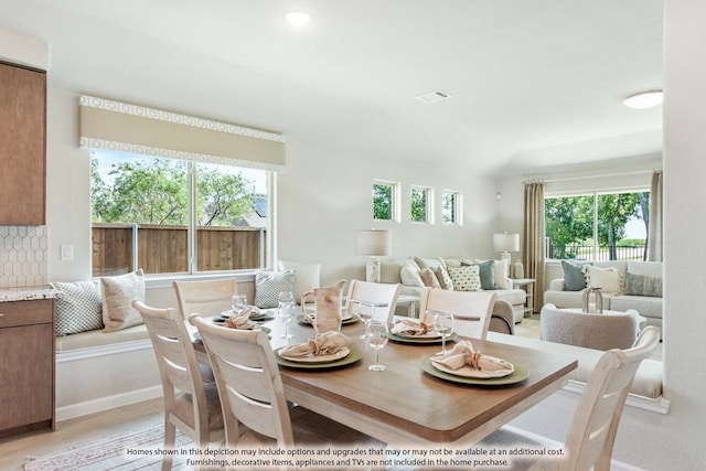 dining space featuring light tile patterned floors