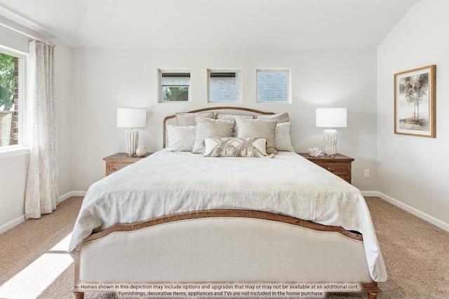 carpeted bedroom with lofted ceiling