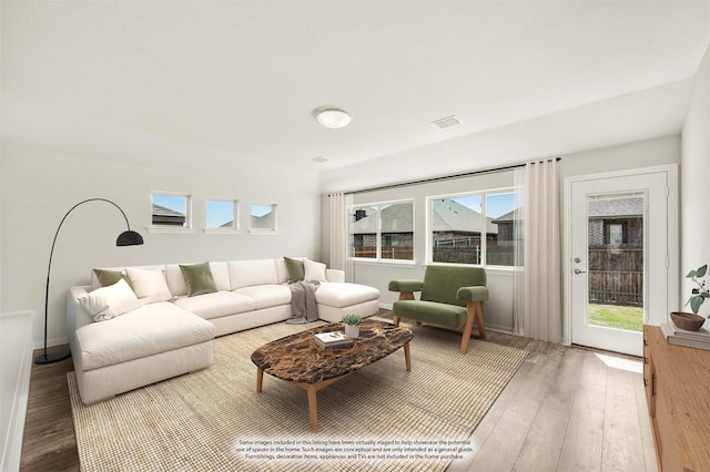 living room with wood finished floors and visible vents