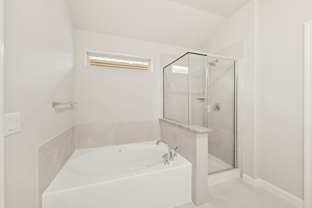 bathroom featuring a shower stall, tile patterned flooring, and a garden tub