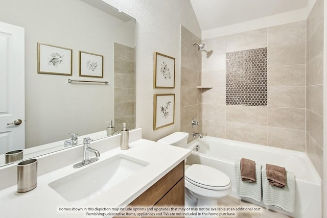 full bathroom with vanity, toilet, tiled shower / bath, and vaulted ceiling