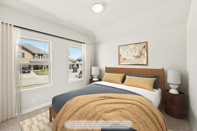 carpeted bedroom with vaulted ceiling, visible vents, and baseboards