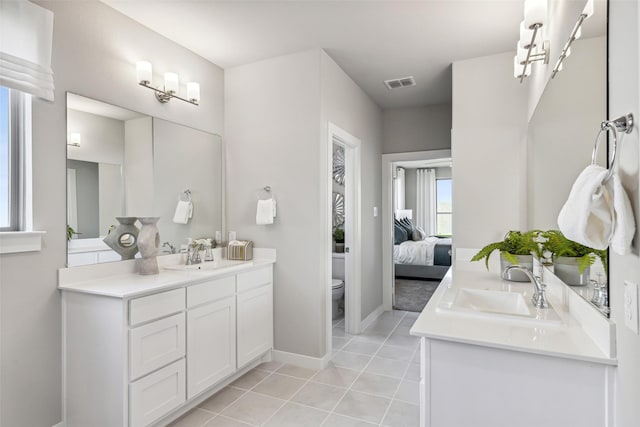 bathroom with vanity, tile patterned floors, and toilet