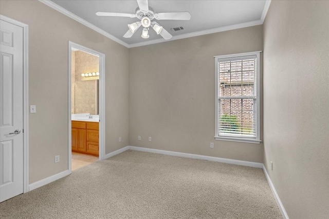 unfurnished bedroom featuring ceiling fan, crown molding, light carpet, and connected bathroom