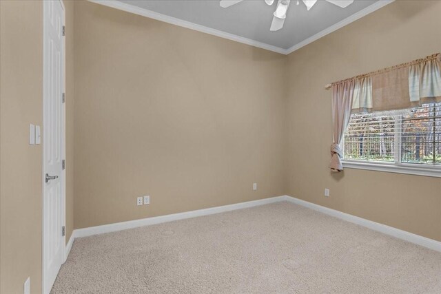 carpeted empty room featuring ceiling fan and ornamental molding