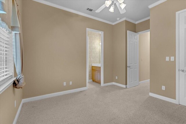 unfurnished bedroom with connected bathroom, light colored carpet, ceiling fan, and ornamental molding