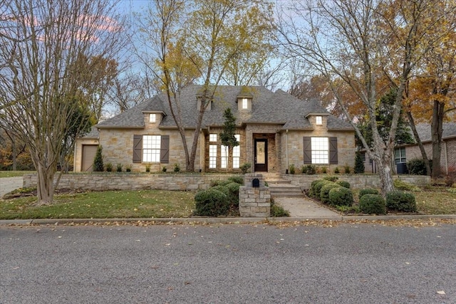 french country inspired facade featuring a garage