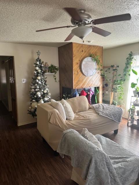 bedroom featuring ceiling fan, dark hardwood / wood-style floors, and a textured ceiling