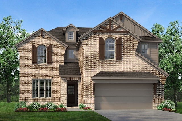 front of property featuring a front lawn and a garage