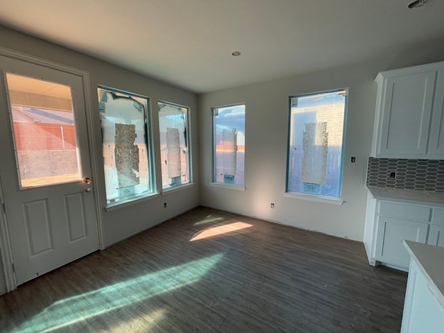 unfurnished dining area featuring dark hardwood / wood-style floors