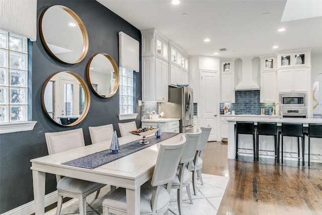 dining room featuring hardwood / wood-style flooring and sink