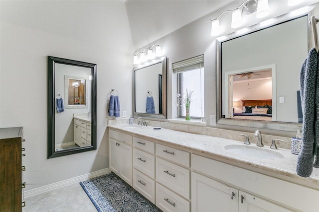 bathroom with tile patterned floors, ceiling fan, vanity, and vaulted ceiling