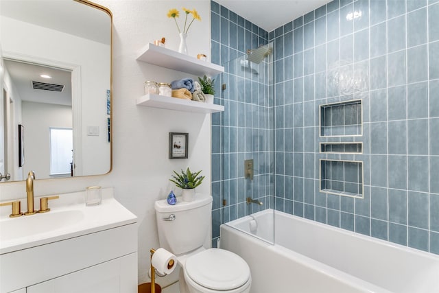 full bathroom with vanity, toilet, and tiled shower / bath combo